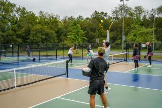 Pickleball Tournament Action Shot Jumping for Return
