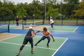 Pickleball Tournament Action Shot Teammates Leaning in for Return