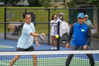 Pickleball Tournament Action Shot Two Teammates About to Return Ball