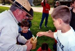 Junior Rangers making peanut butter bird feeders